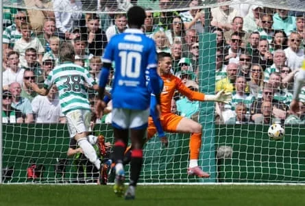 Daizen Maeda of Celtic scores past Rangers goalkeeper Jack Butland